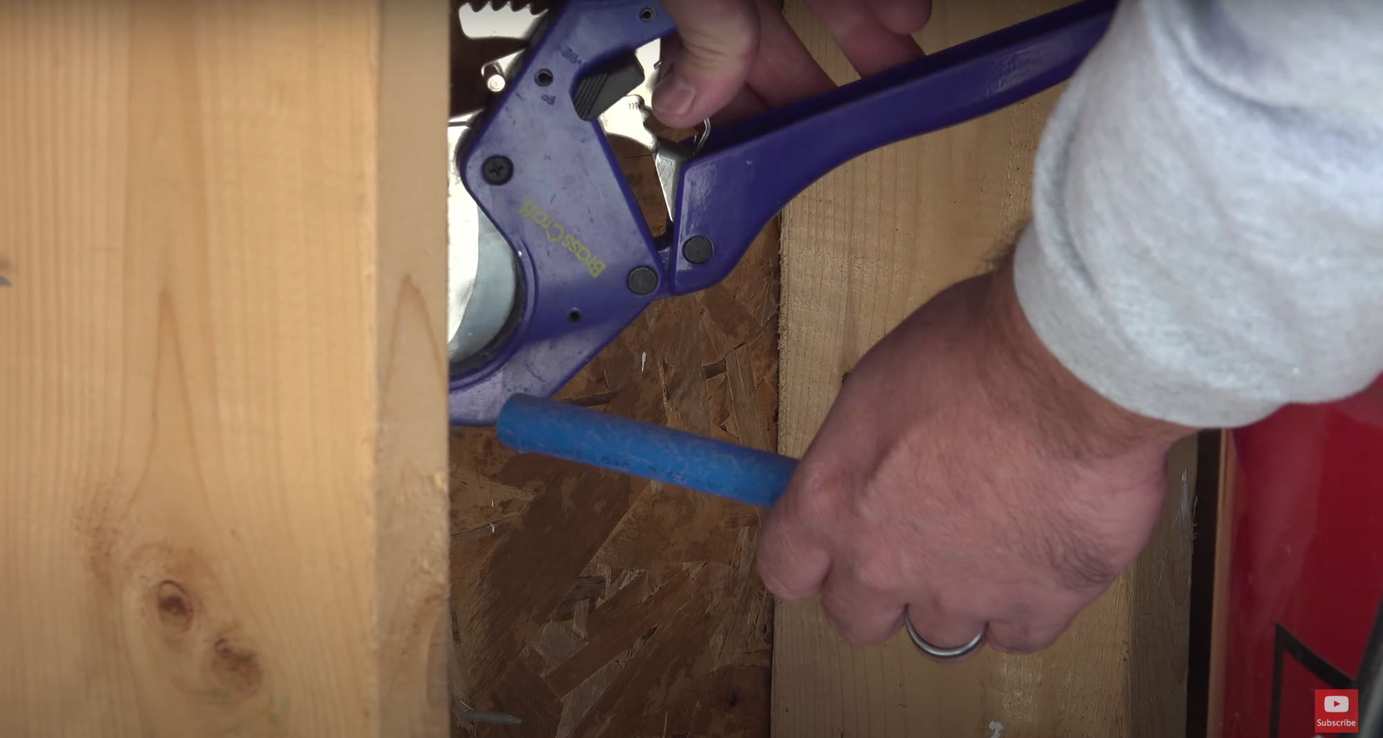 Cutting the PEX plumbing with plastic cutters.