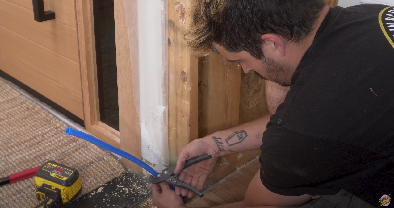 Cutting the PEX to the height of the newly drilled hole.
