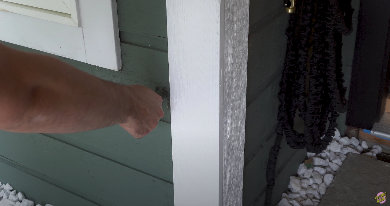 Pulling the disconnected hose bib out of the exterior wall