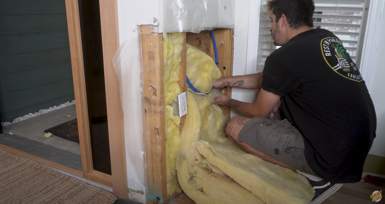 Putting the insulation back in place around the PEX.