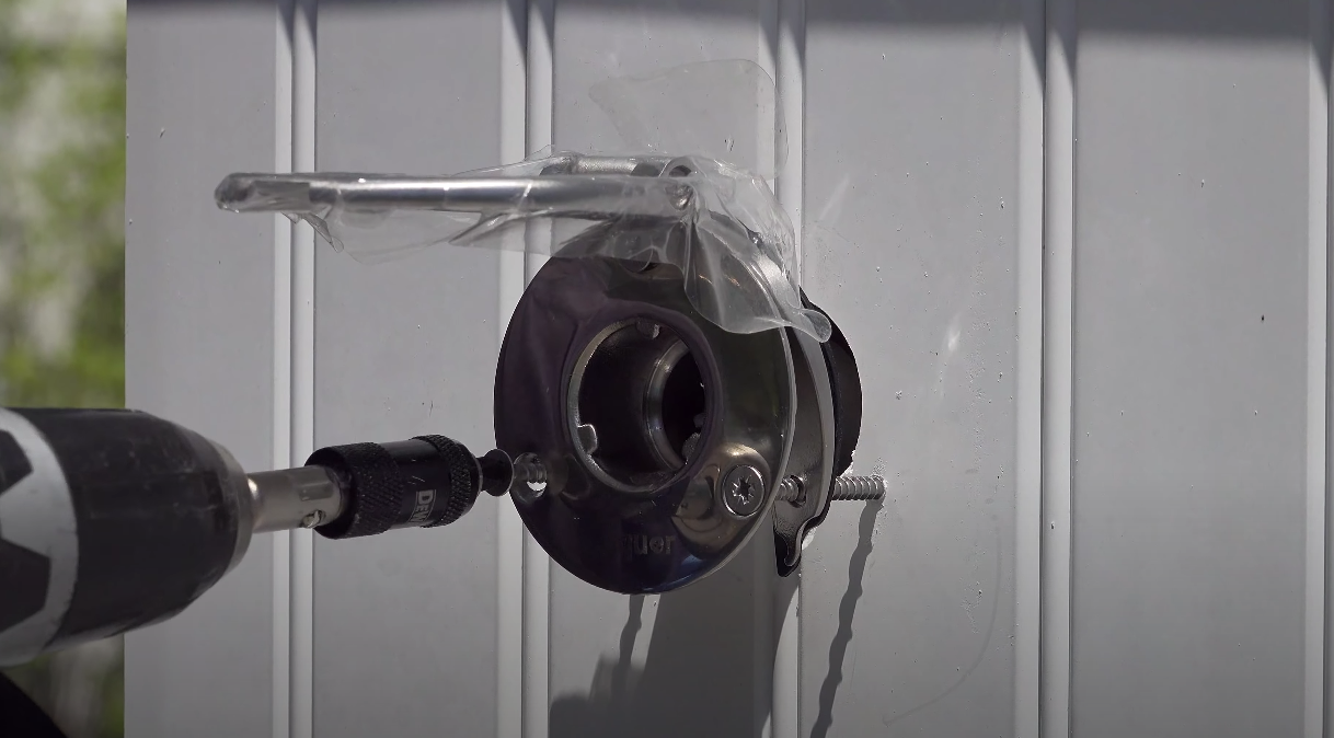 Screwing the Hydrant into the PVC cabinet with predrilled holes.