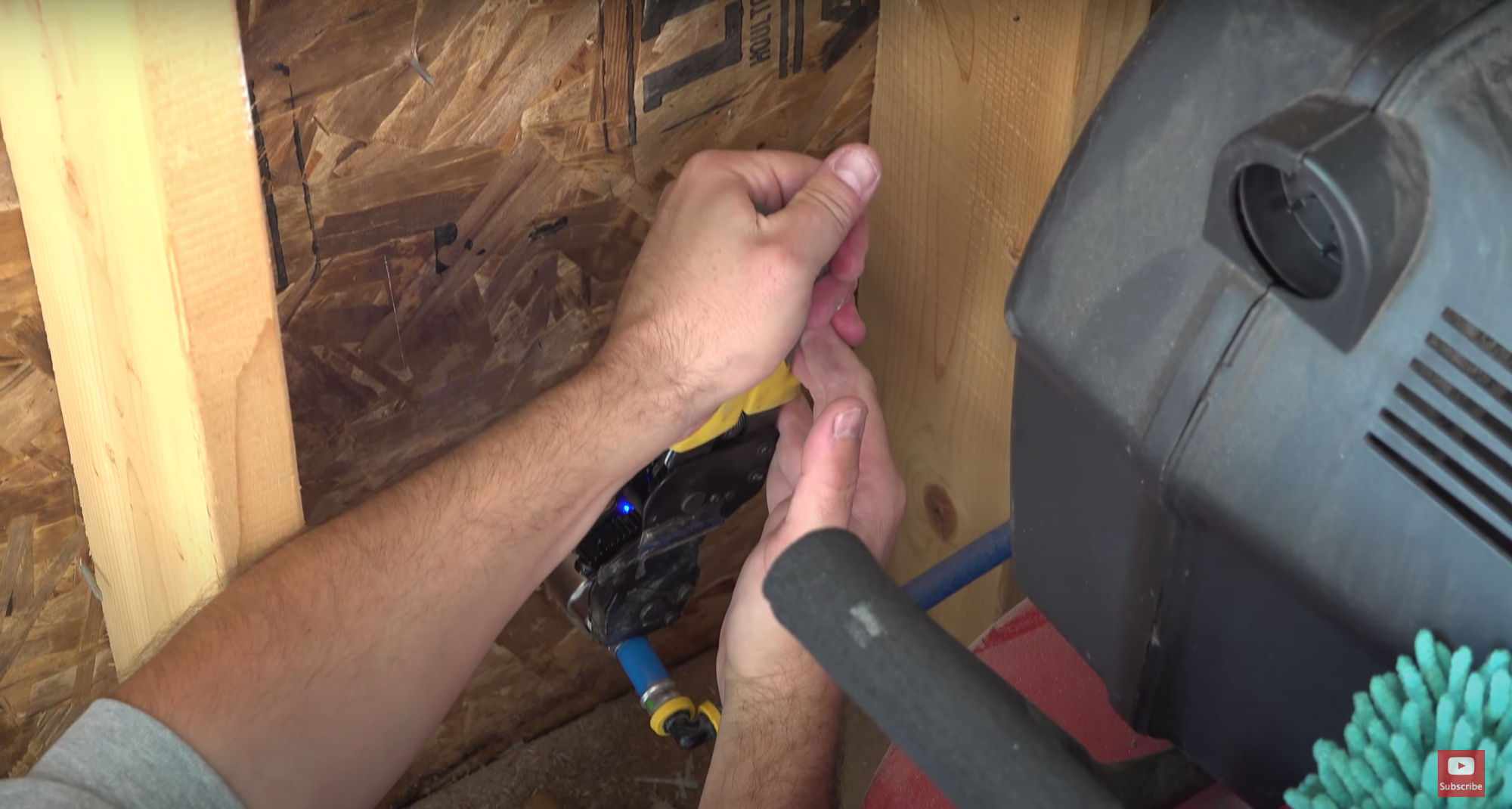 Using a crimp tool to complete the plumbing connection.