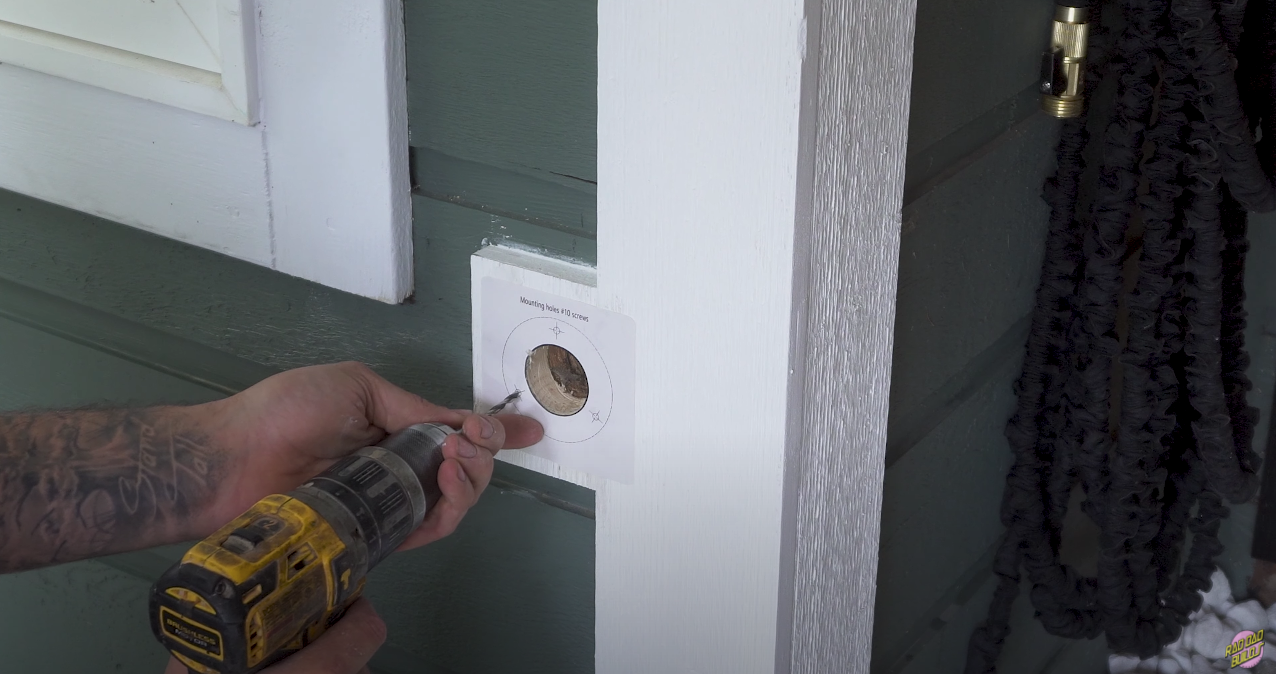 Using the included template to aid in positioning the predrilled screws